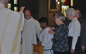 Thomas Gomes, CSC, Receiving a Blessing from the Family of Holy Cross