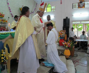 Bishop Devotta lays hands on Gnanam during his Ordination