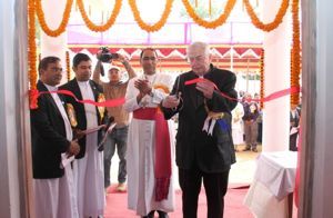 Fr Warner cuts the ribbon at the dedication of Holy Cross College in Agartala