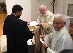 Mr Felipe Campos, CSC, receives his letter of obedience from Fr O'Hara, CSC