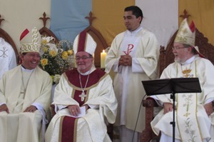 Bishop Izaguirre, Bishop Colgan, and Bishop Strotmann share a light-hearted moment in the Mass of Ordination