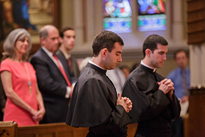 Ryan Pietroclaro, CSC, And Michael Palmer, CSC Pray For God's Blessing During Their Final Vows Mass