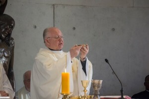 Fr Robert Epping, CSC, offers the Eucharist