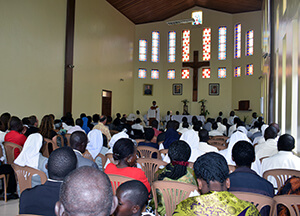Fr. Abraham preaching viewed from back of the church