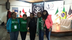 Fr Jose Luis Tineo greets pilgrims arriving for the Holy Cross Youth Gathering in Lima