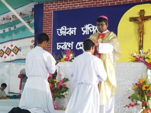 Bishop Tudu ordains Khokun and Bikash to the Deaconate