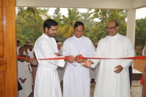 Fr Leo D'Souza cuts the ribbon for the new St André Home