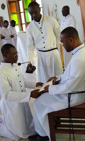 Br John Badu Affum, CSC, receives the First Vows of one of the novices in 2018