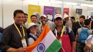 Fr Pinto Paul, CSC, takes a picture with Indian pilgrims to WYD at the Vocations Fair