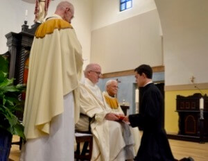 Fr William Lies, CSC, Provincial Superior, receives the First Vows of the 12 novices