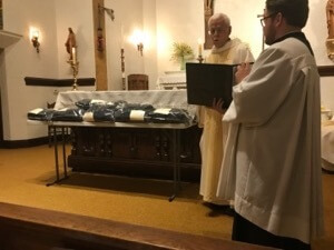 Fr Ken Molinaro, CSC, Novice Master, blesses the habits of those to profess First Vows