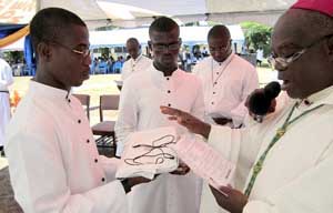 Archbishop Nketsia blessings the St Joseph Medals