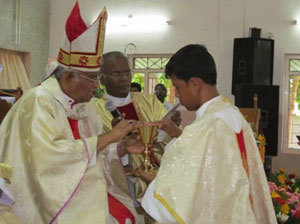 Fr Gnanam receives the patent and chalice at his Ordination Mass