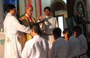 Archbishop D'Rozario prays over the four brothers professing final vows