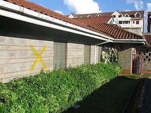 The previous house of formation in Kenya with the yellow x's marking it for demolition