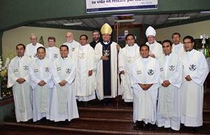 The Holy Cross priests in attendance take a photo with the newly ordained