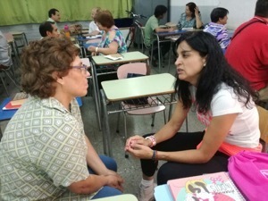 Two parishioners from San Roque discuss the INFAM presentation