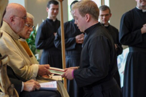 Andrew Fritz professes his vows to Fr O'Hara