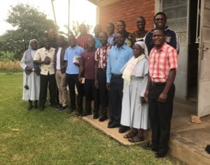 Fr David Eliaona, CSC, takes a picture with the novices during the 2018 pre-profession retreat in East Africa