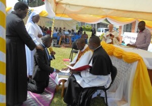 Fr Henry Kajubi, CSC, receives Mr Kansiime Simon Peter, CSC's First Vows