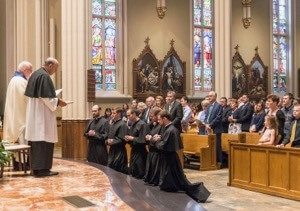 Fr Bill Lies prays for the five men to profess their Final Vows