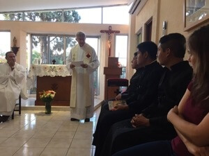 Fr Thomas Zurcher, CSC, speaks to the men in formation during the Mass