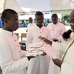 Most Rev. Matthias Nketsia Archbishop of Cape Coast Ghana blesses the medals of St. Joseph given to members of the Brothers Society upon Final Vows in Haiti.