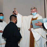 Mr. Angel Alberto Lazaro de la Cruz, C.S.C., receives his Profession Cross from Fr. Thomas Zurcher, C.S.C.