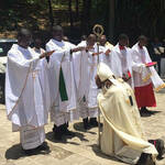 Bishop receiving blessings from newly ordained priests in Haiti.