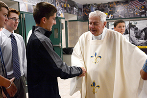 Fr Warner greeting students after Mass
