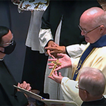 Fr. William Lies, C.S.C., presents Mr. Robert Lisowski, C.S.C., with the Final Vows profession cross in the United States.