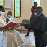 Mr. Gideon Muriithi Kinyua, C.S.C., receives his profession cross in the presence of community, family, and friends. Fr. Cyprian Binaka, District Superior, received the vows and also presided and preached at the Mass.