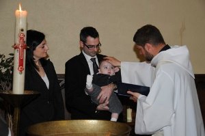 Fr Paul Valentin, CSC, at a Baptism