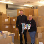 Fr. John Phalen, C.S.C. with rosaries sent around the world by Holy Cross Family Ministries